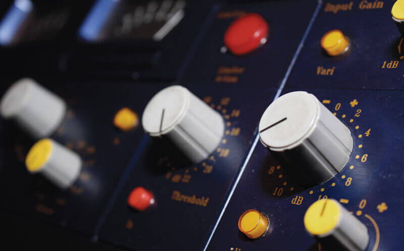 Sound engineer mixing and mastering a track in a professional studio